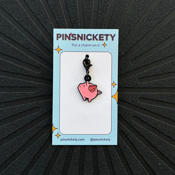 pinsnickety flying pig braid bridle and bonnet charm on a black background