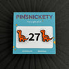 pinsnickety orange brontosaurus horse show number pins on a black background