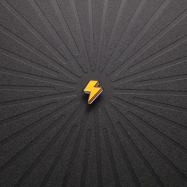 pinsnickety lightning bolt horse show number pin in special edition electric yellow alone on a black background